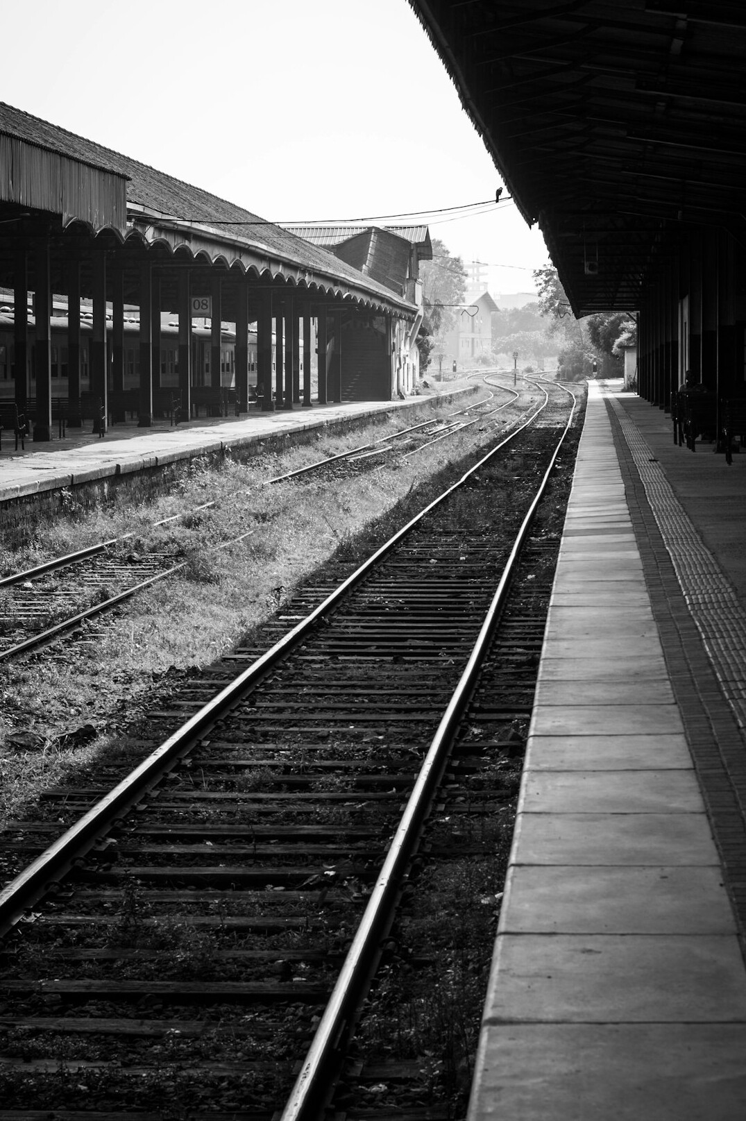 Abandoned railway station platform with old rails