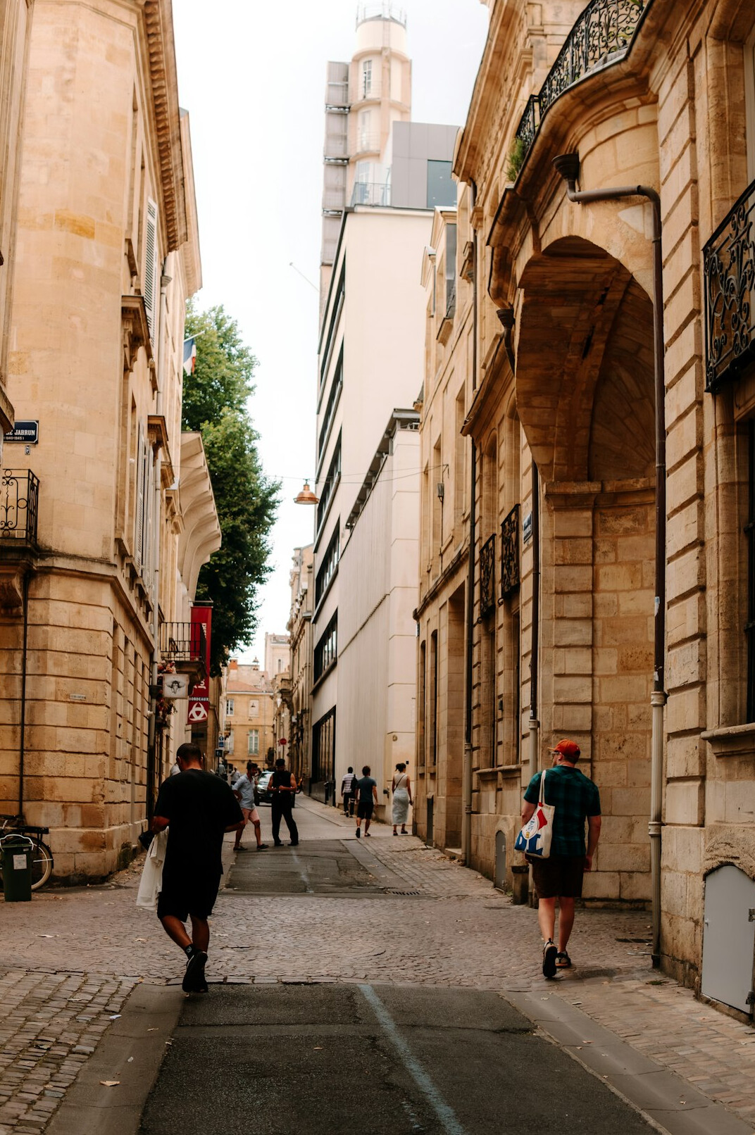 Man journalist with notebook walking in old city street